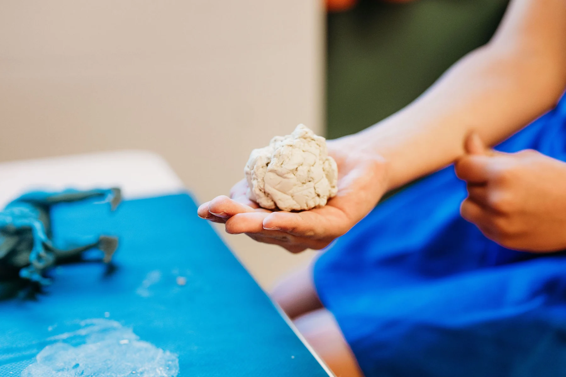 A child exploring clay during a creative activity