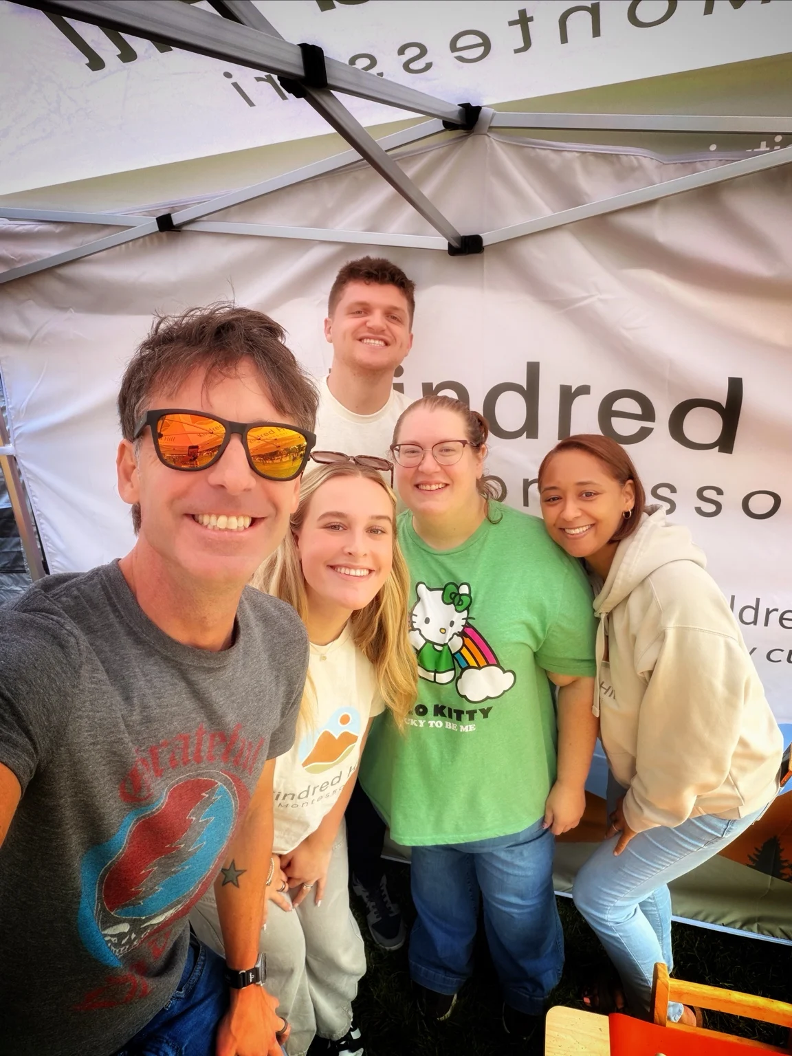 Kindred Hill team members smiling together at the festival booth